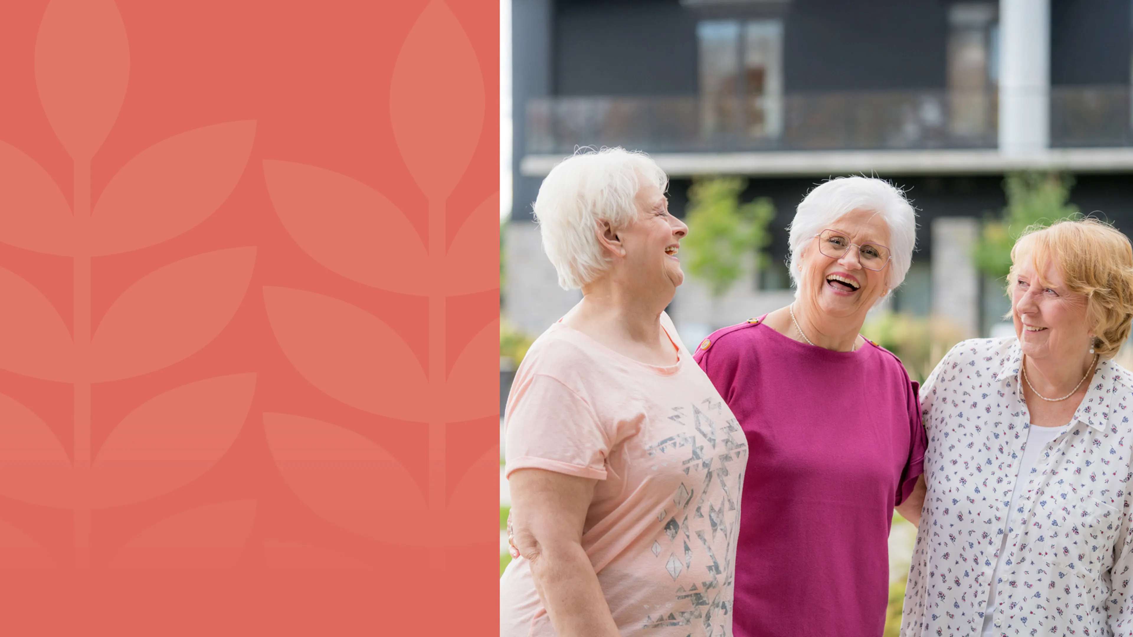 Three seniors ladies embrace outside while laughing.