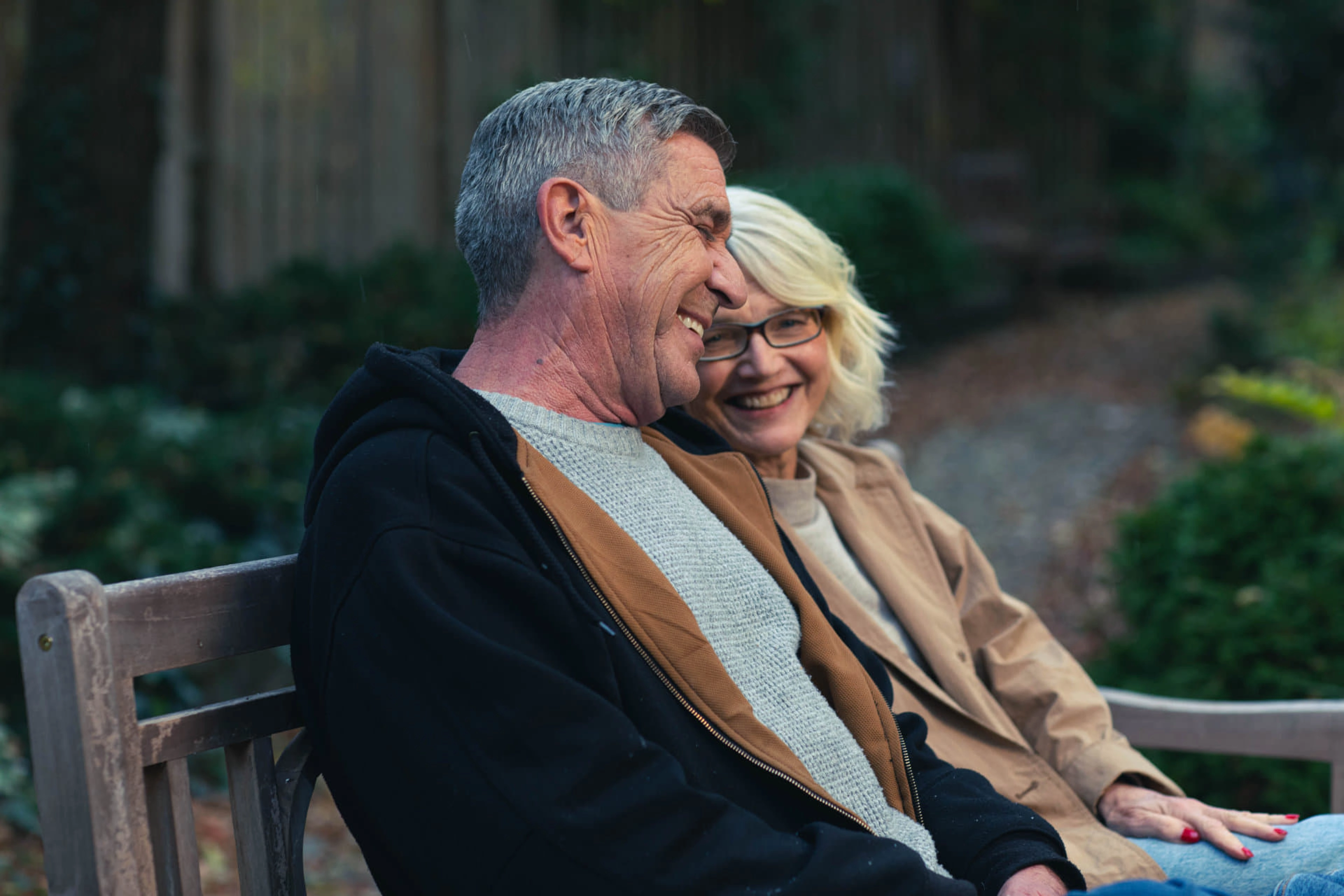 An older couple sitting on a bench