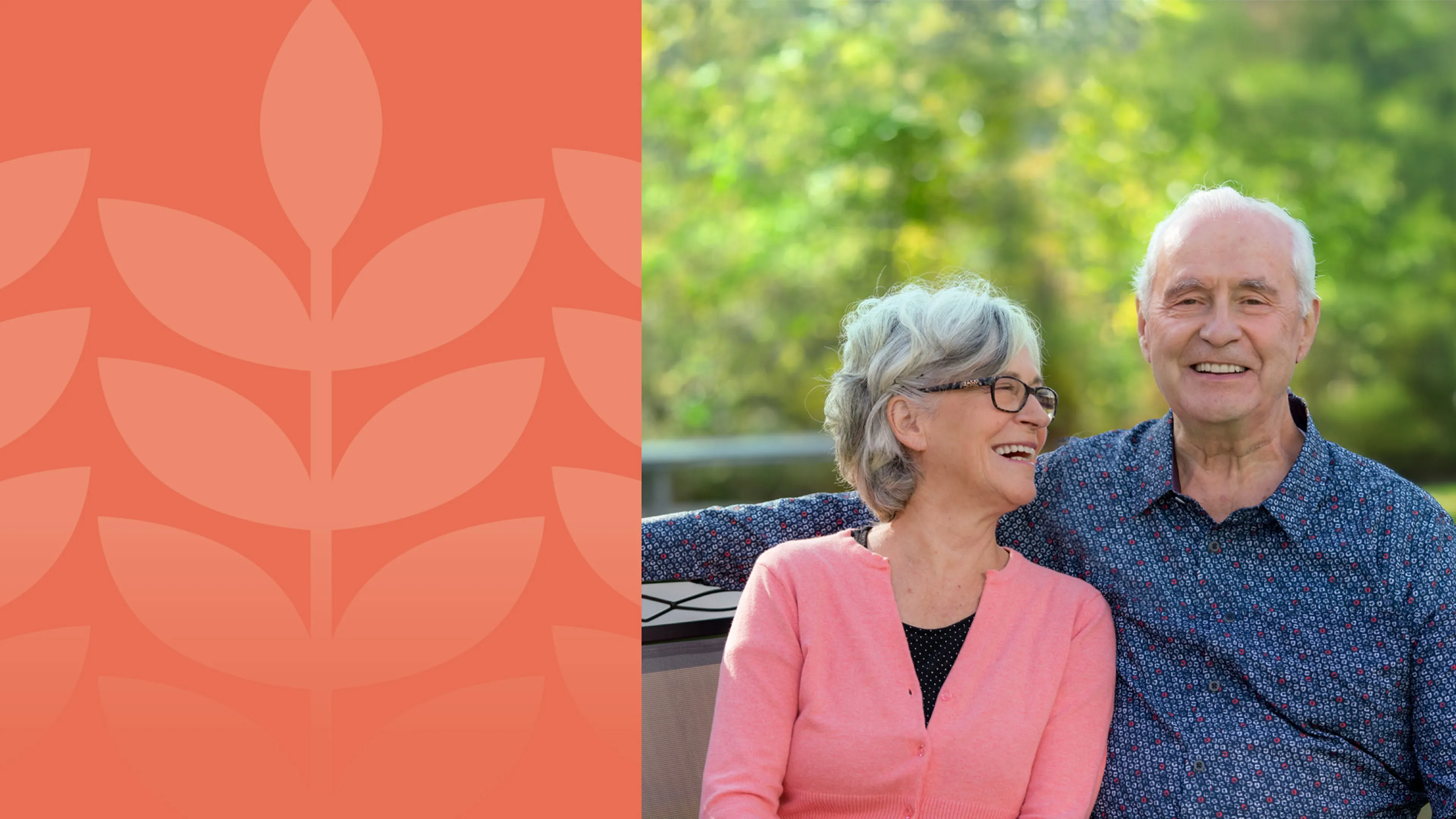 A senior couple smile and laugh together on a park bench