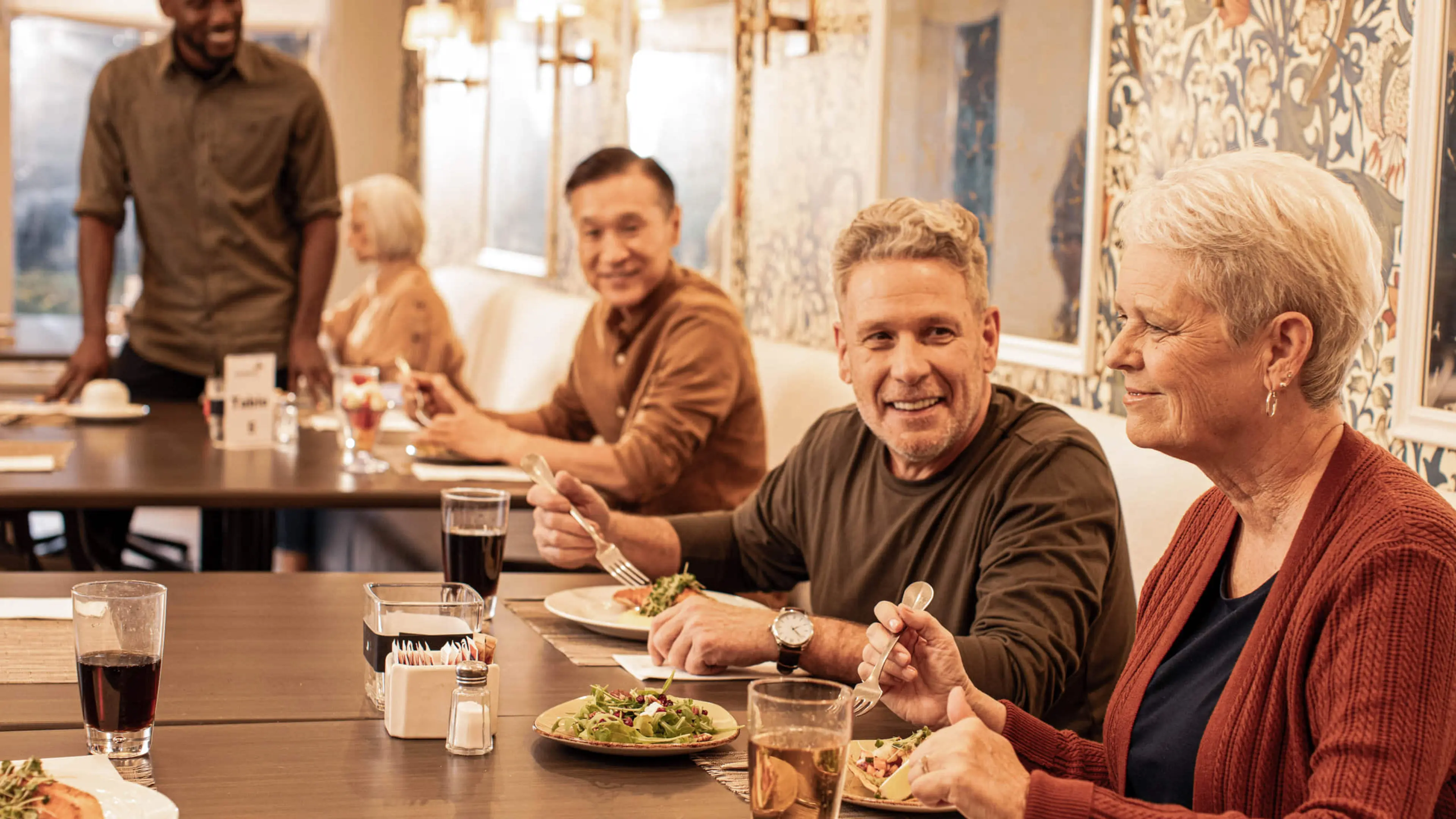 Older adults enjoying a meal in a common dining room