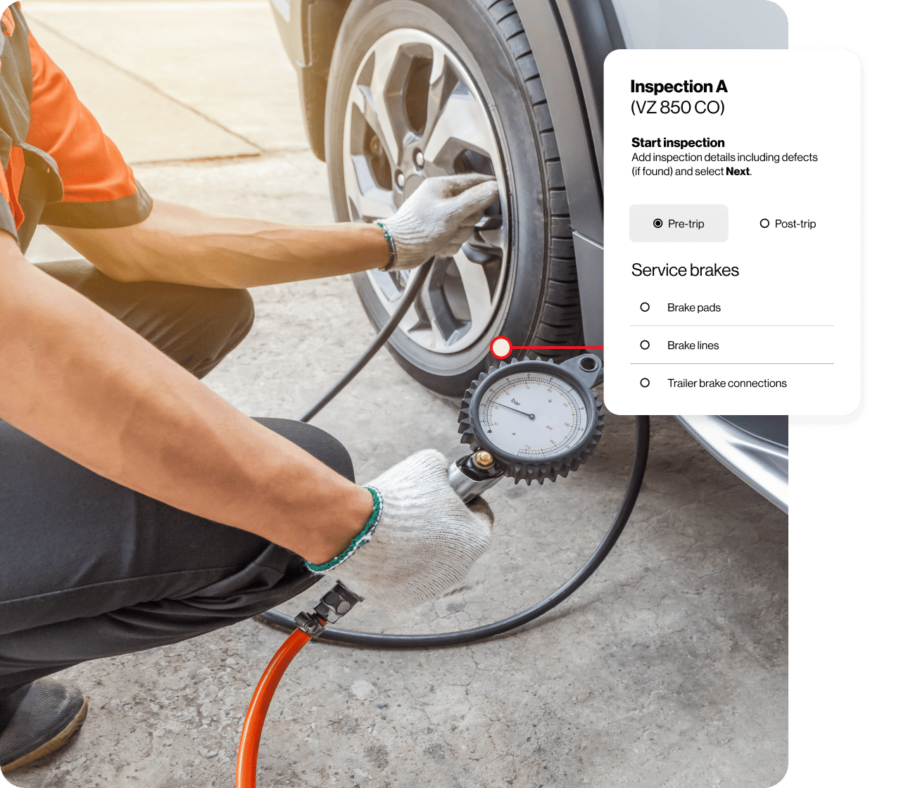 An inspector checking the tire pressure of a car