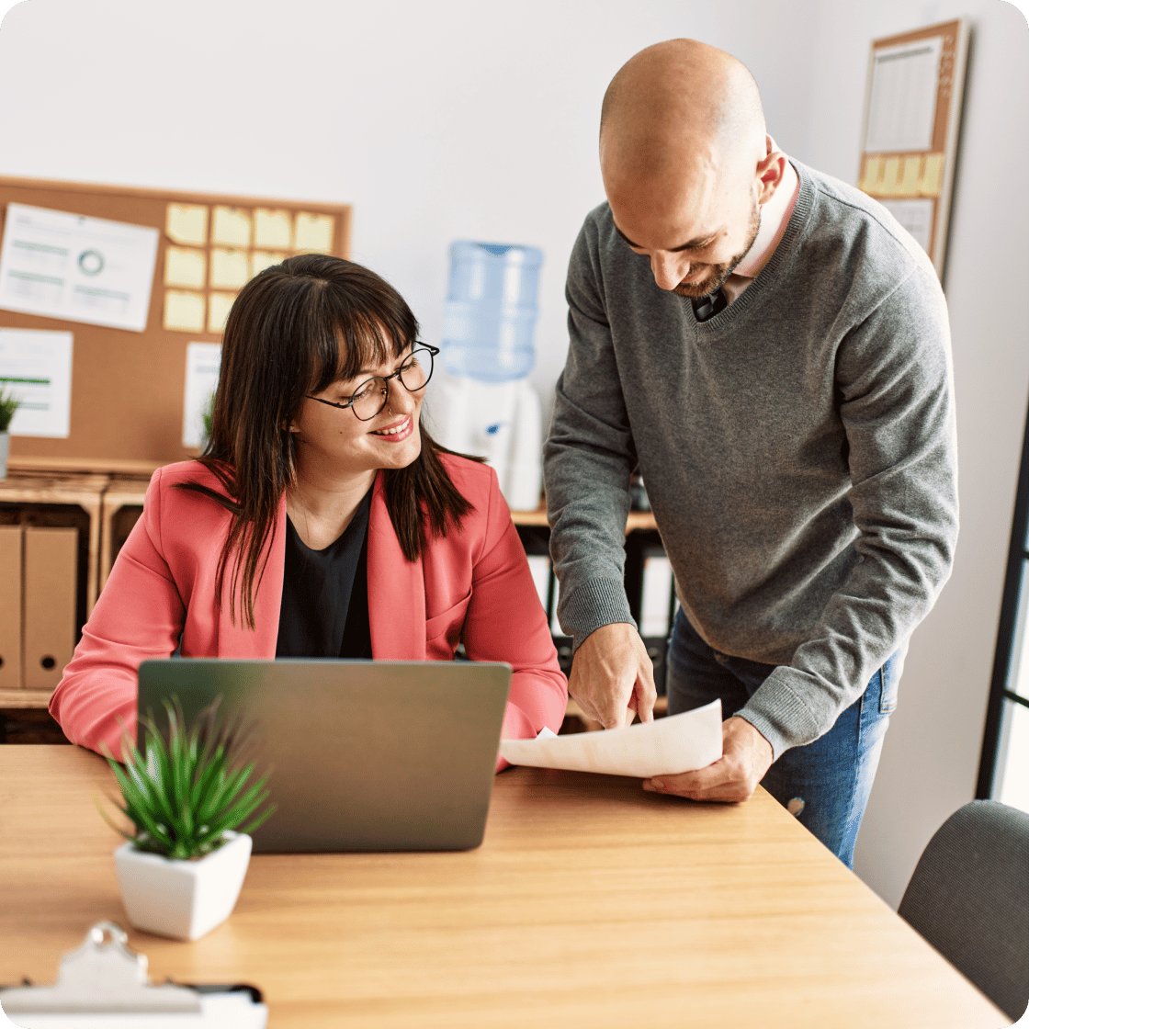 A woman and man reviewing a document