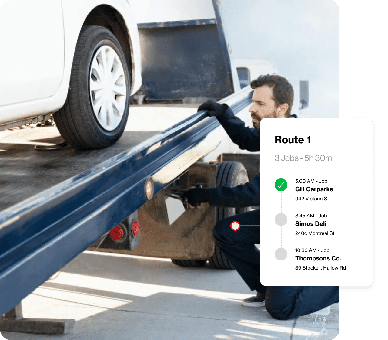A car being loaded onto a flatbed truck