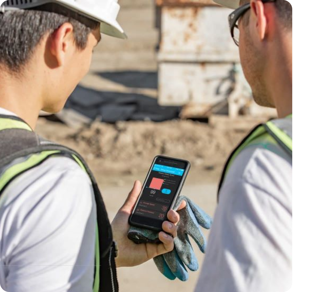 A man showing a coworker fleet data on his phone