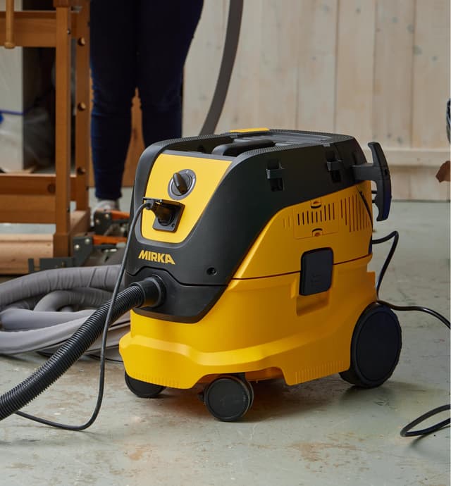 A Mirka dust extractor being used in a workshop