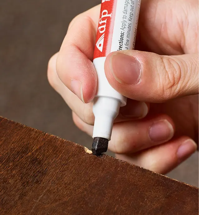 Covering a nick in a finished surface edge using a furniture touch-up marker