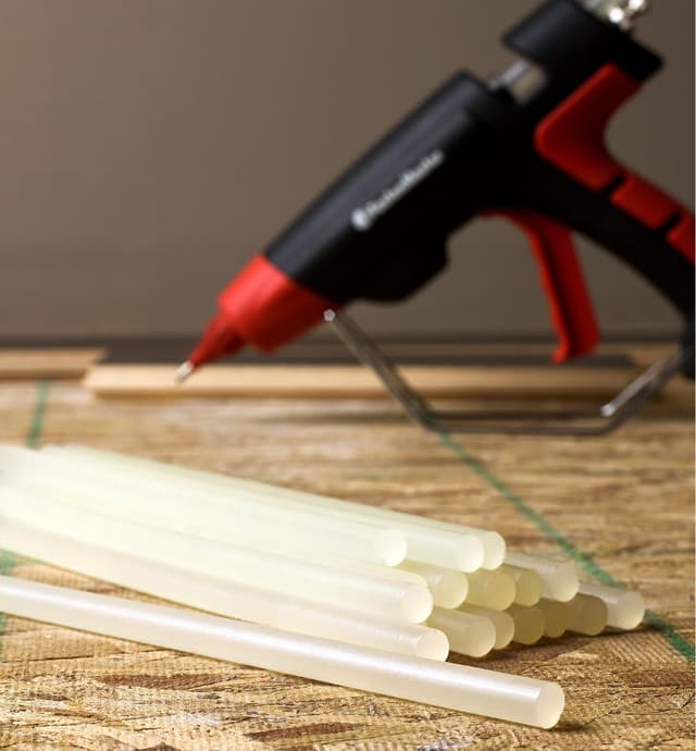 Flex 180 glue sticks and the FastenMaster pro hot-melt gun being used to install flooring