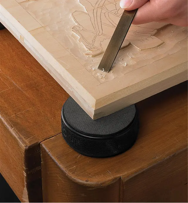 Carving a workpiece that is resting on a Bench Puck work standoff