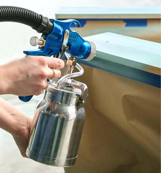 Spray painting a piece of wood using the Earlex spray station