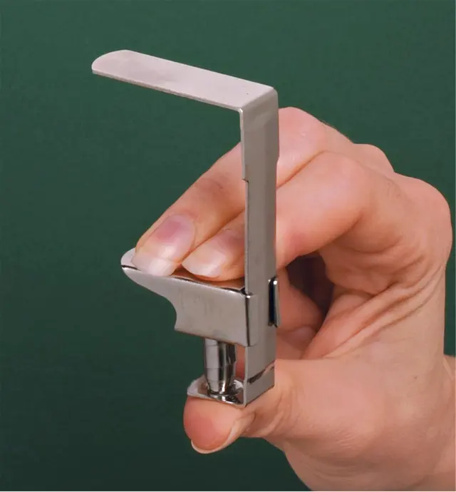 Holding a tablecloth clip to show the spring action