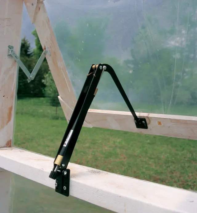 Installed Heat-Activated Window Opener holding a window open