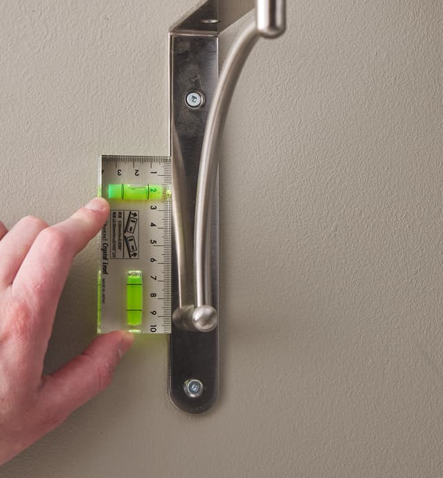 Using a crystal level to algin a shelf bracket vertically