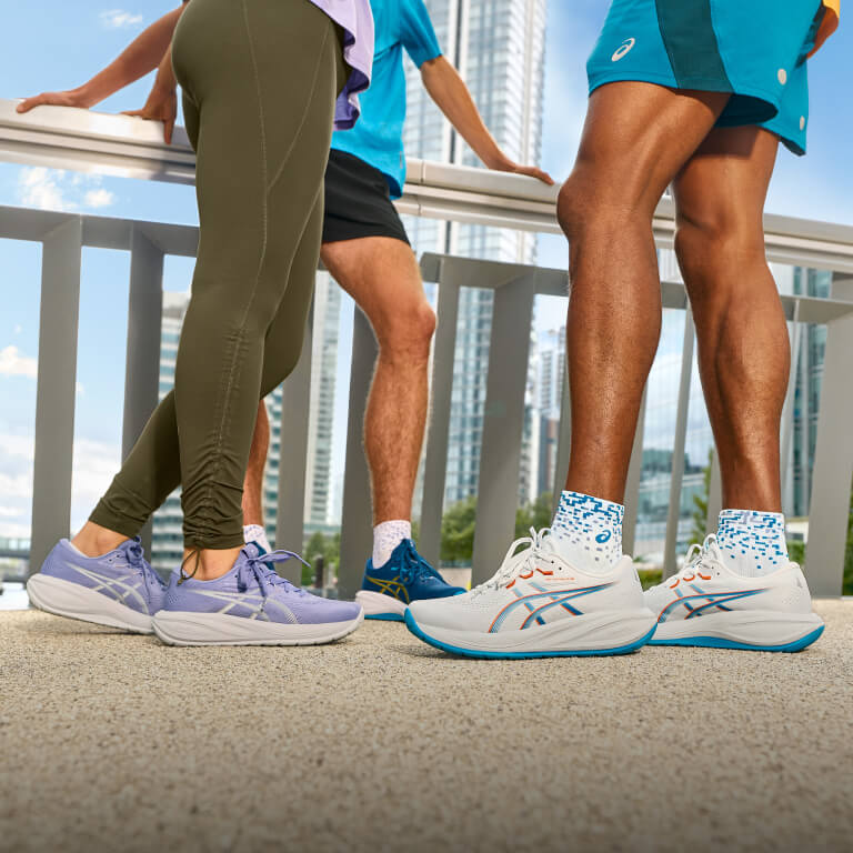Runners standing on a bridge wearing ASICS GEL-NIMBUS™ 28