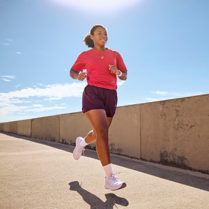Woman running wearing Nagino Bloomstride sneakers