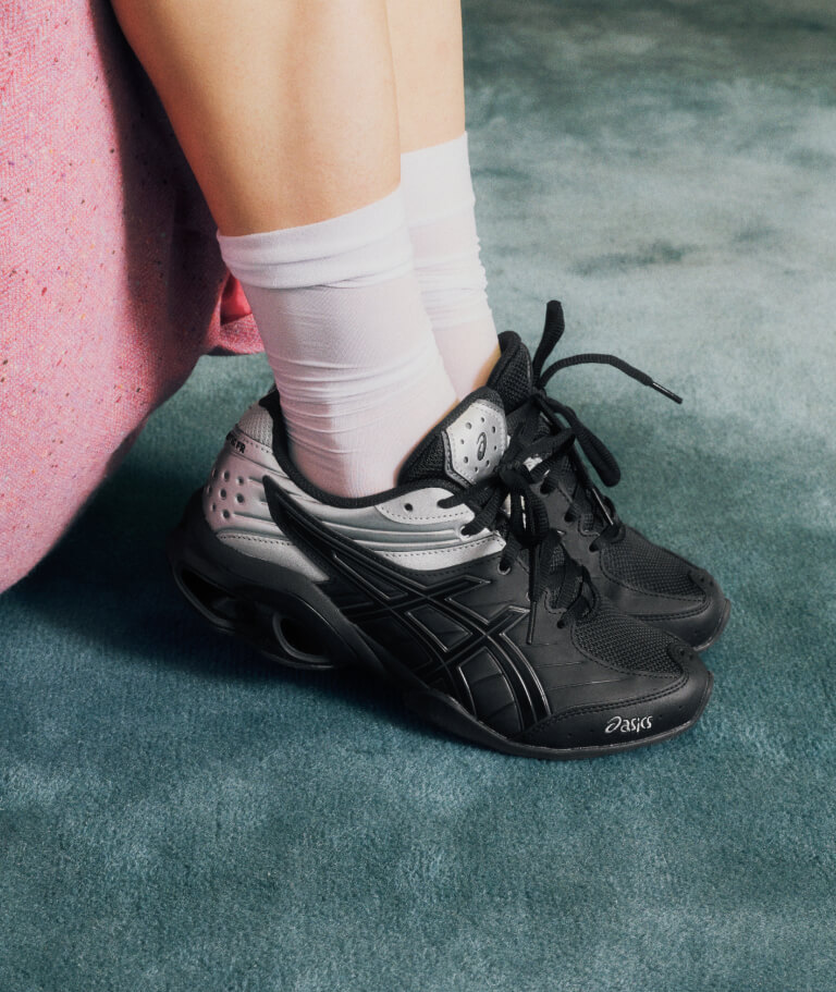 Woman wearing ASICS SportStyle GEL-KINETIC FR sneaker in black