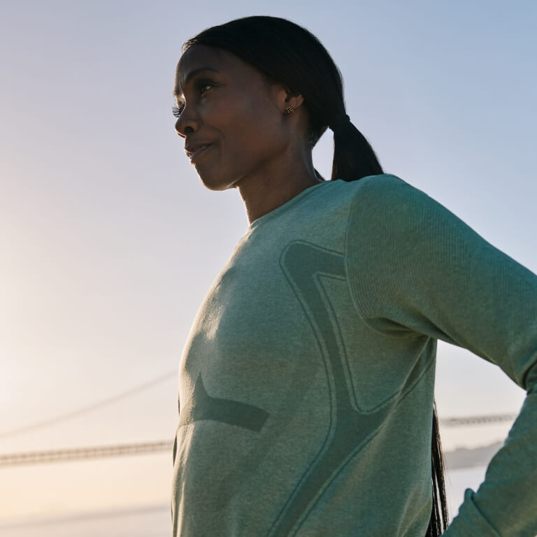 Woman wearing ASICS Nagino longsleeve and standing outside