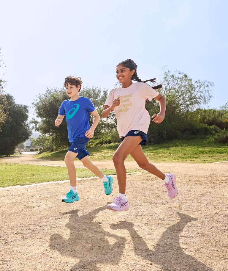 Kids running in nature with ASICS Kids running gear