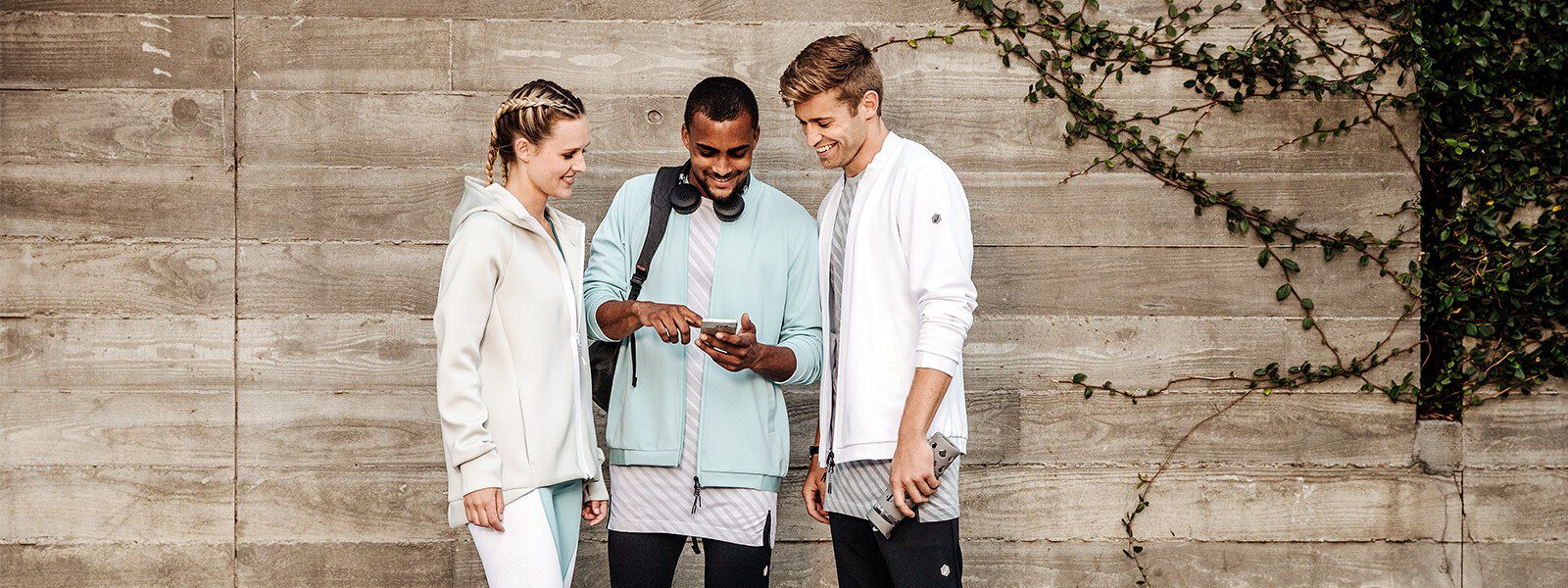 3 fit looking people looking at a mobile phone