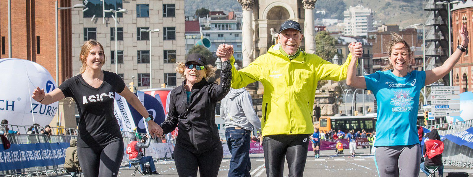 A group of people running outside smiling