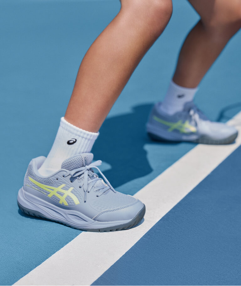 Child wearing ASICS tennis shoes