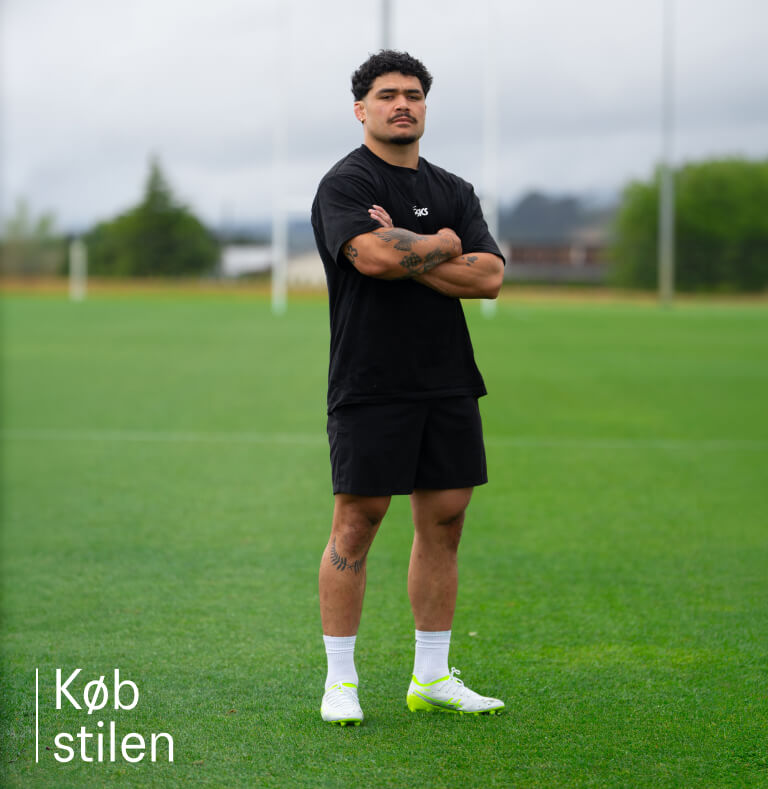 Rugby player wearing black ASICS clothing and rugby boots