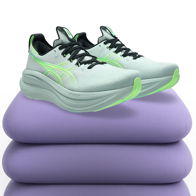 GEL-NIMBUS 28 in green colorway resting on a purple pillow