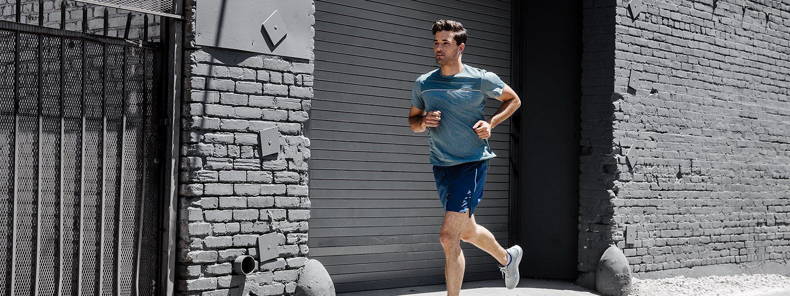 A runner wearing ASICS clothing and running shoes running outside