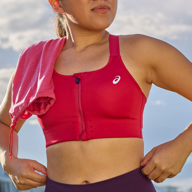 Woman wearing ASICS Road combination zip bra