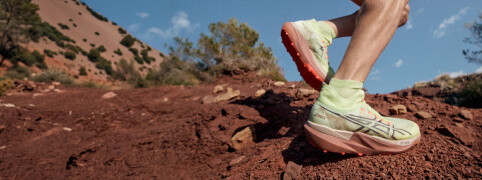 Male Runner in mountain environment running in Metafuji Trail ASICS shoes
