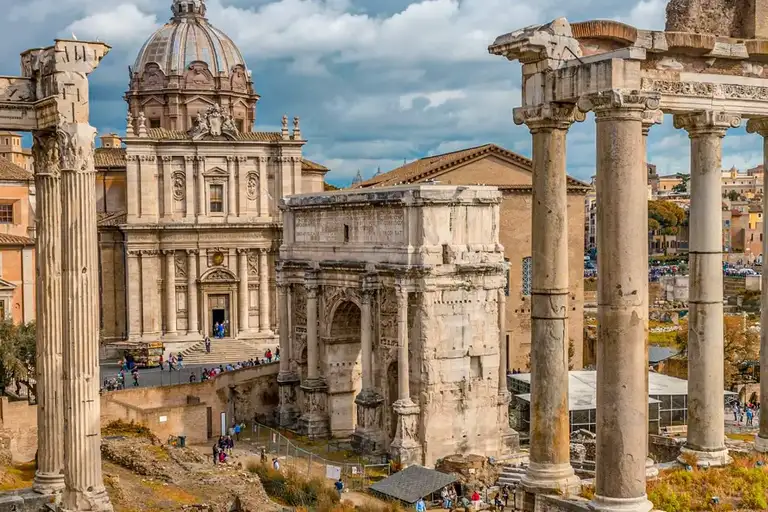 A panoramic view of the Roman Forum, with tourists taking pictures