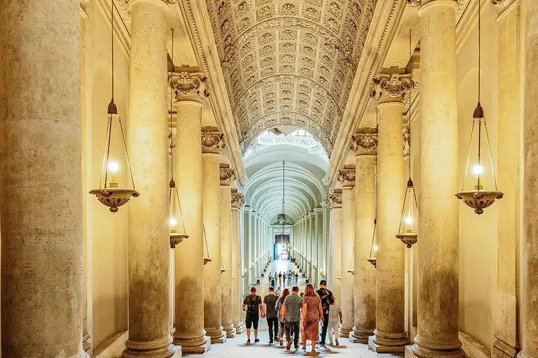 Tourists exploring the halls of the Vatican Museums