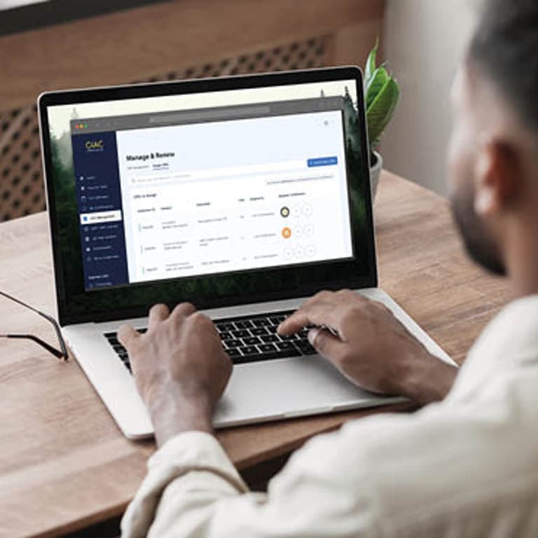 Man Typing on Laptop