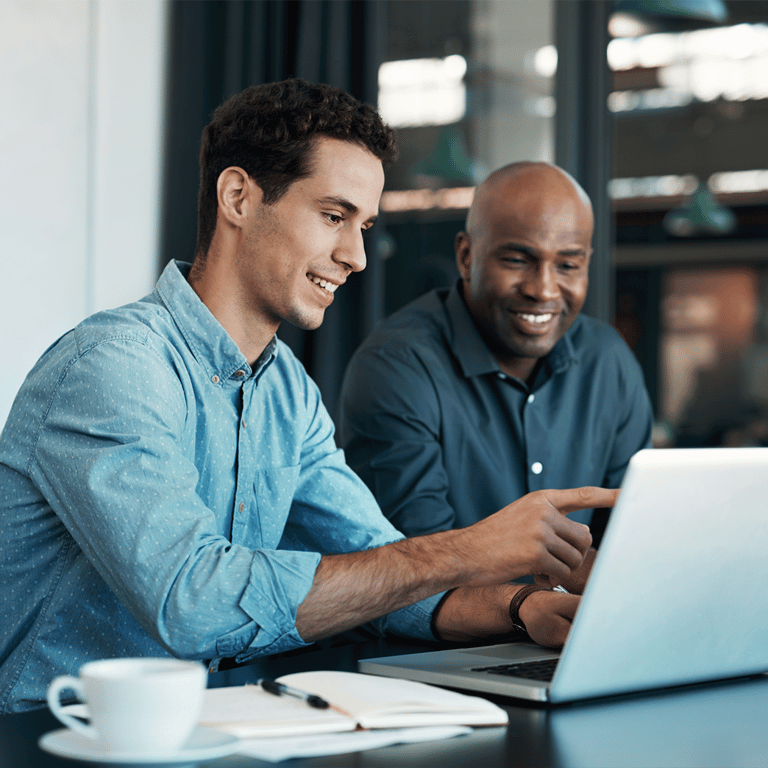 Two men studying on a laptop