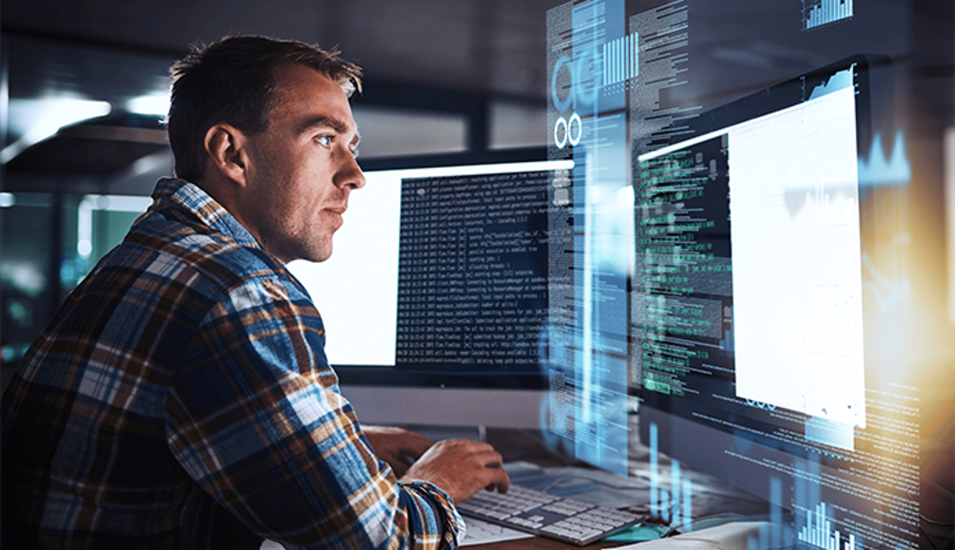 Man working at desk on computer with code