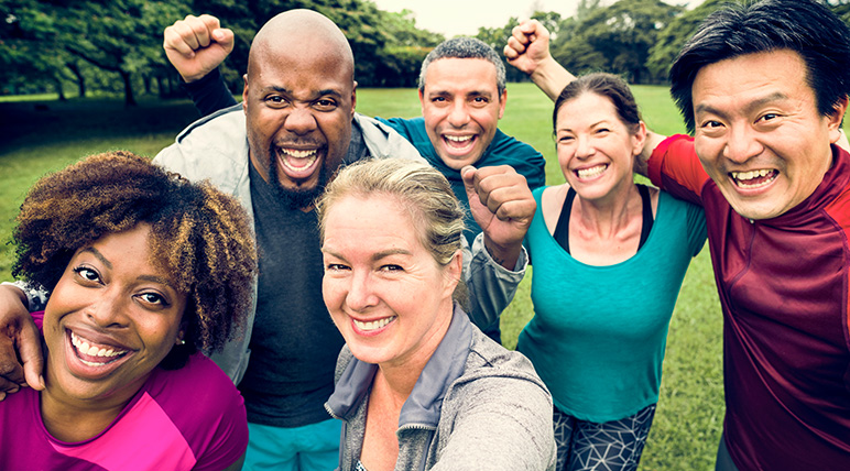 Group of people smiling at the camera looking happy and healthy.