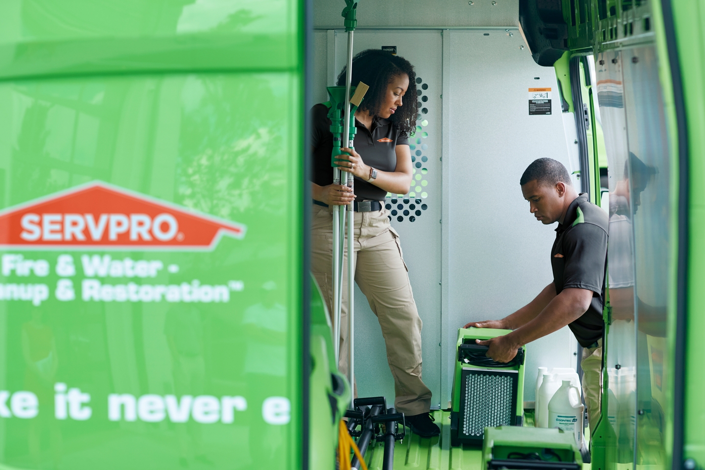 SERVPRO employees taking equipment out of van