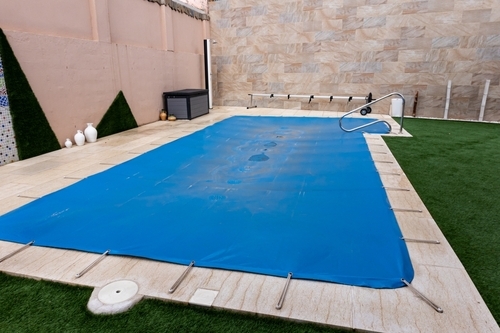 Cleaning a pool cover is part of routine pool maintenance