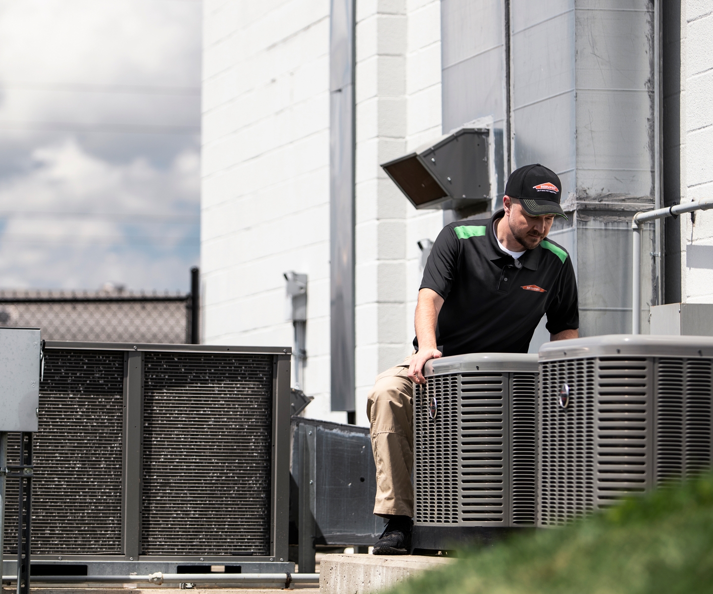 man outside doing hvac service and air duct cleaning