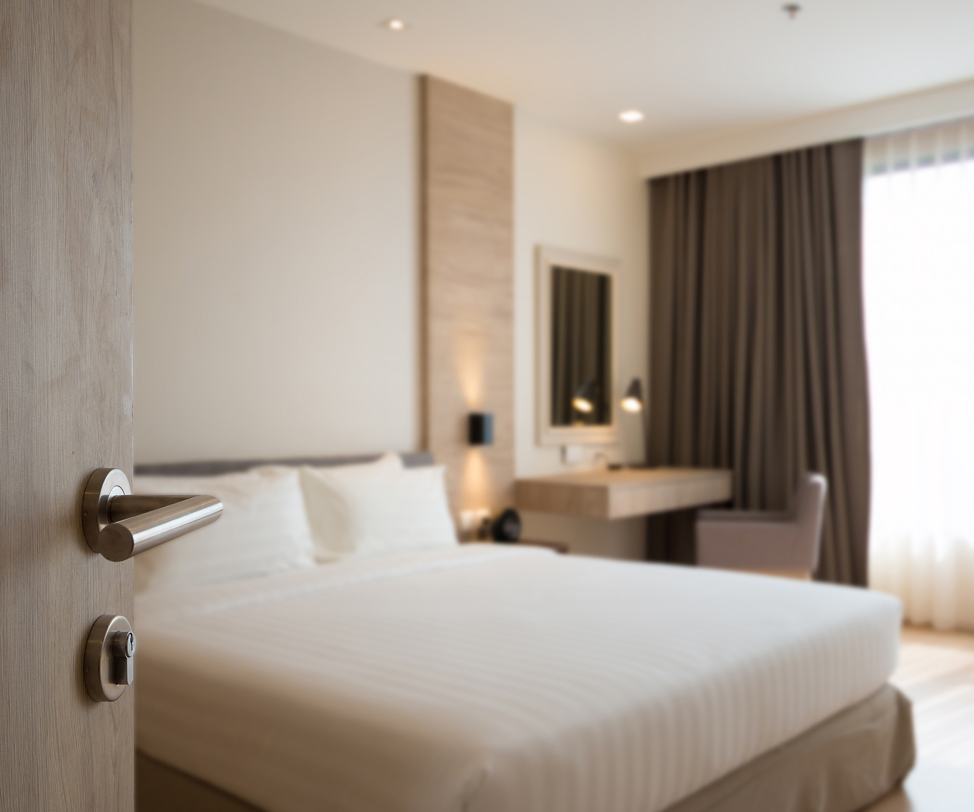 Interior view of bed and window in hotel room
