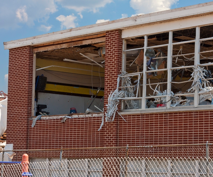 Commercial building with windows ripped out from storm