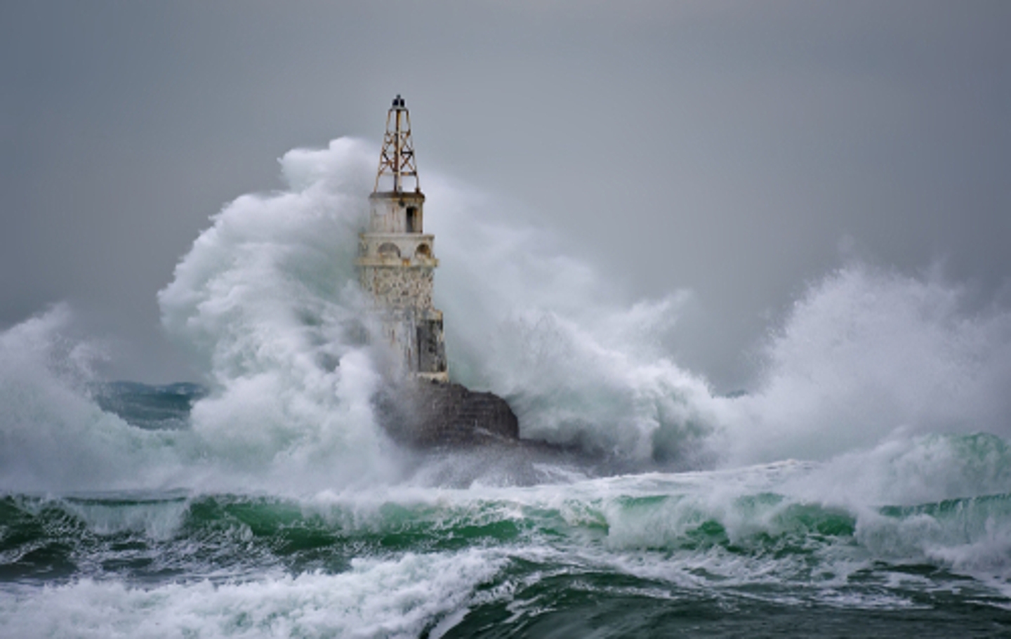 Stormy weather and thrashing water around lighthouse