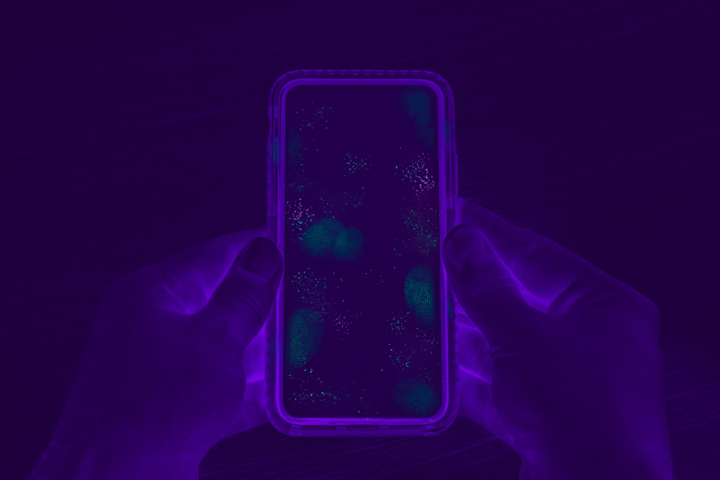 Photo of phone in the dark with purple lighting around it