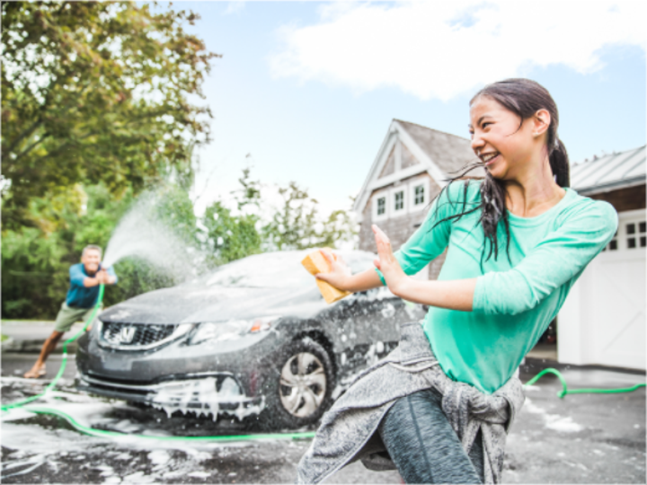 Man and Woman Playfully Washing Car