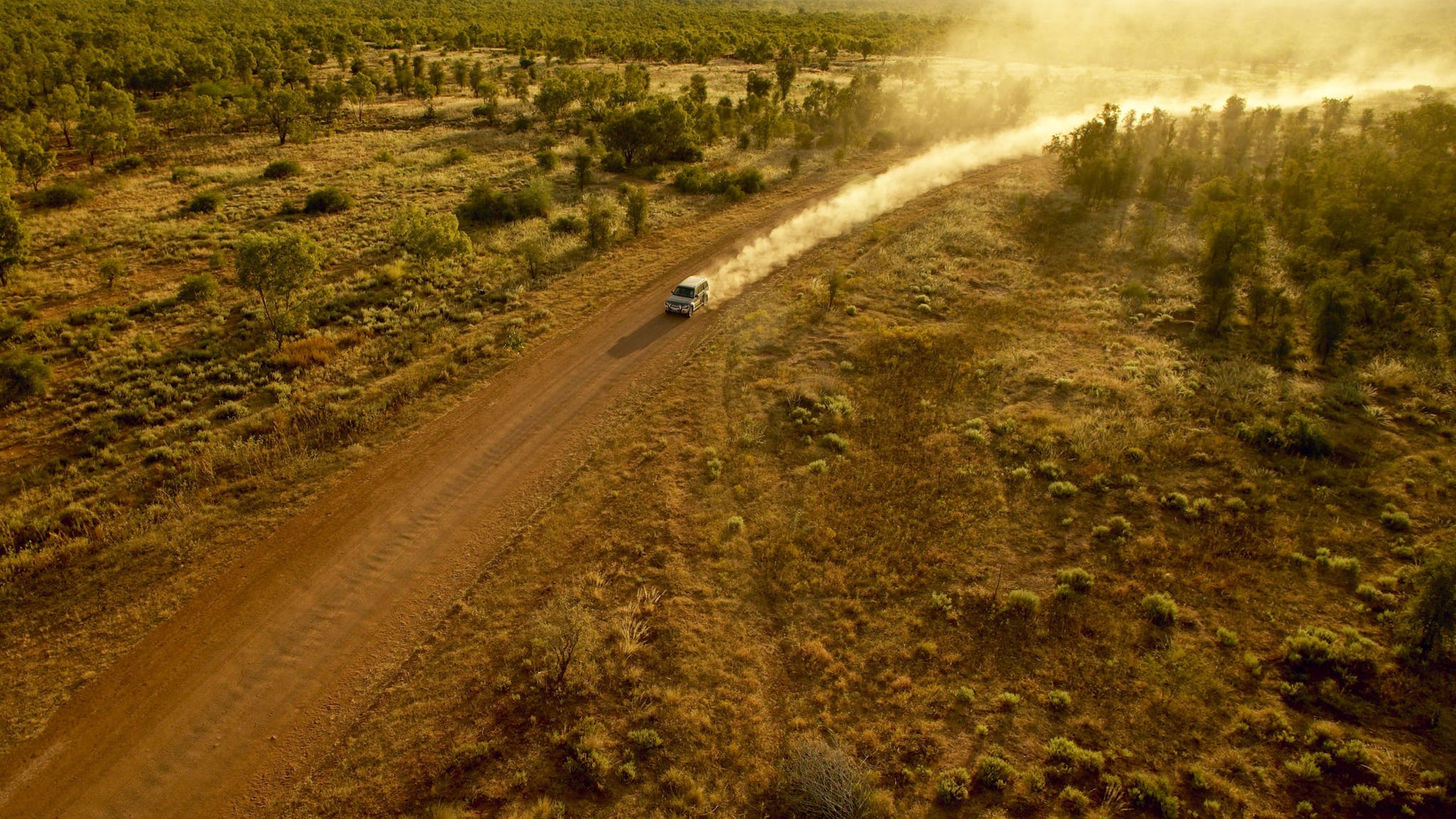 Car driving on dirt road in outback NT