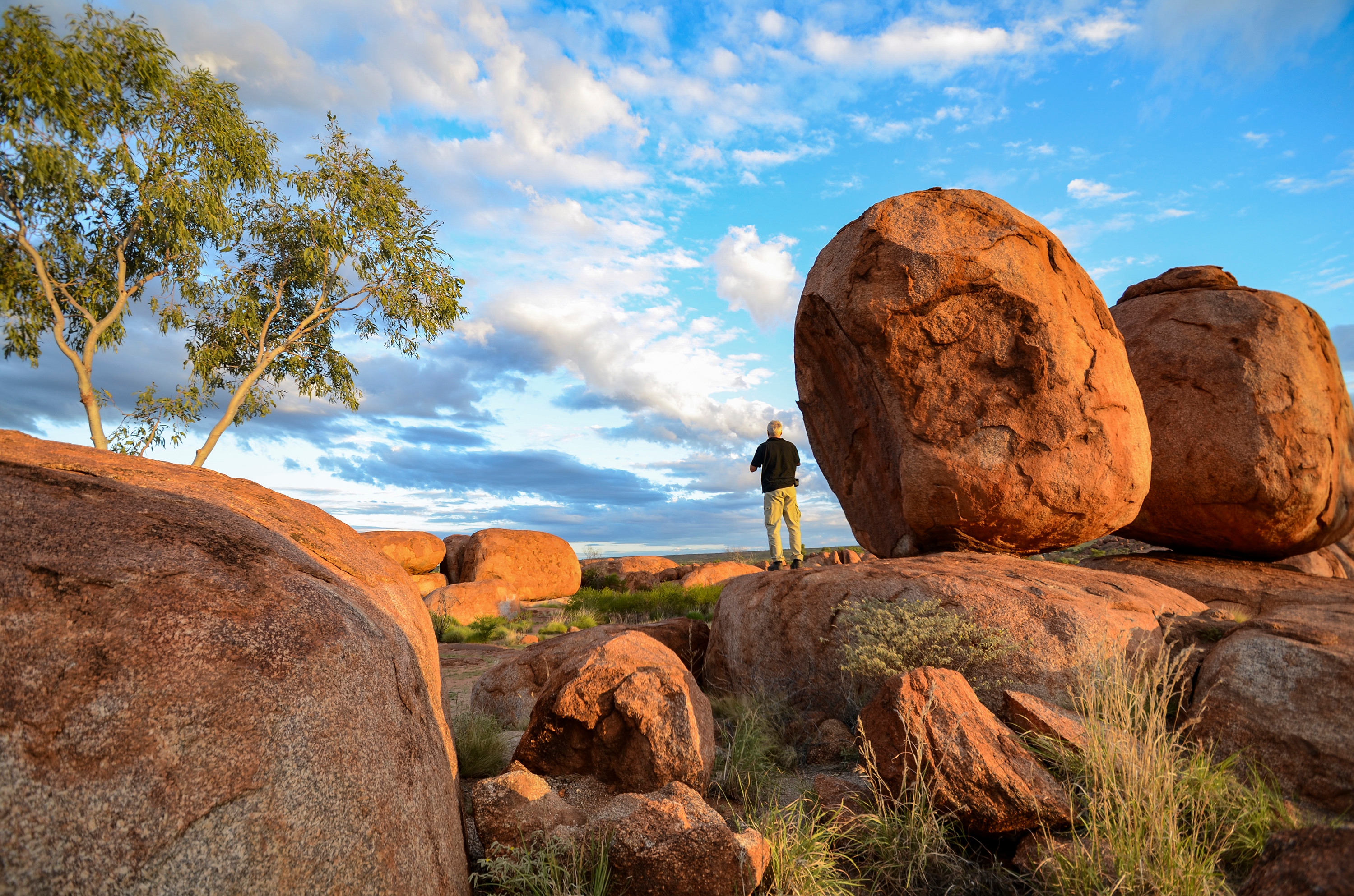 Man taking a photo at Devils Marbles