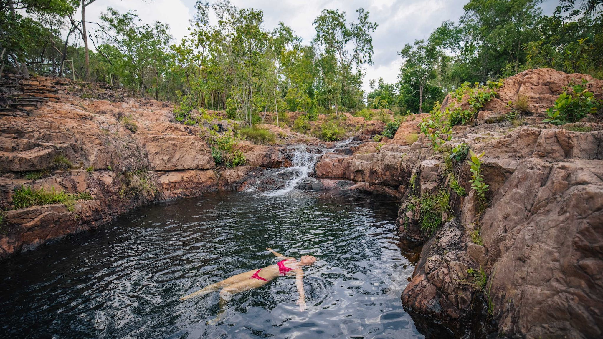 Woman floating in water at Bulley Rockhole in Litchfield National Park