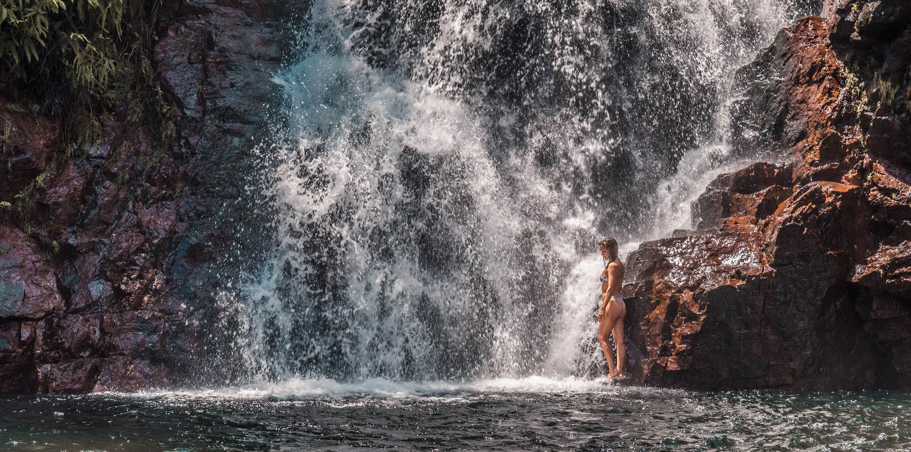 Girl at the bottom of a waterfall in Litchfield National Park (1)