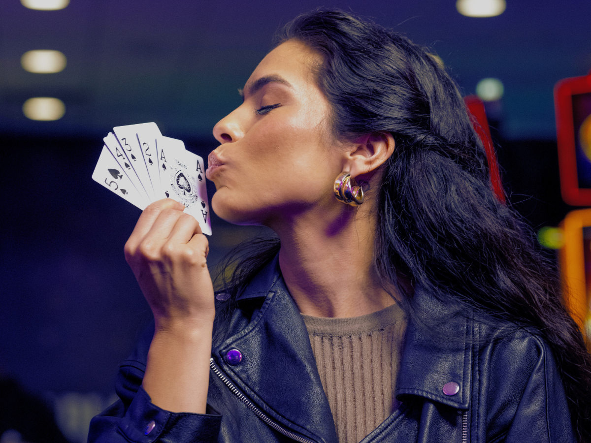 Woman holding a poker straight flush hand