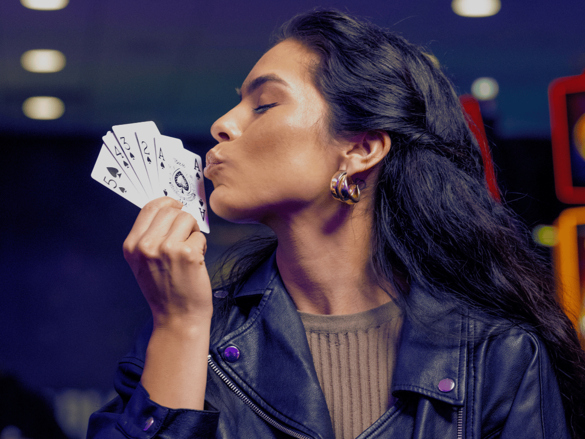 Woman holding a poker straight flush hand