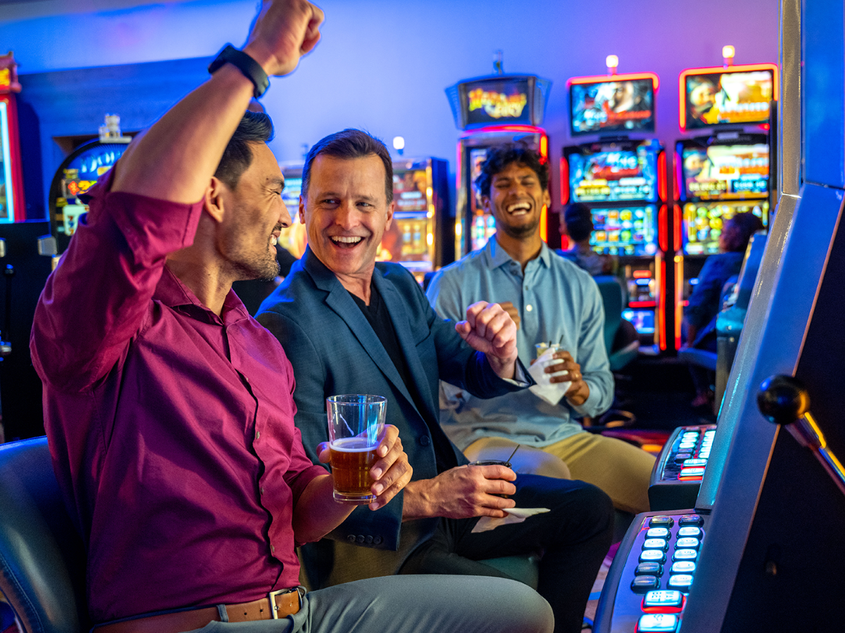 Group of friends playing slot machines